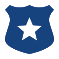 A blue police badge with a black star on it.